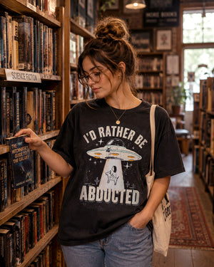 Retro UFO graphic illustration abducting a dog with I'd Rather Be Abducted lettering on a Comfort Colors t-shirt