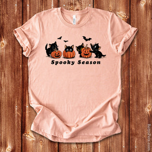 Spooky Season Halloween cat t-shirt in Heather Peach on wood background