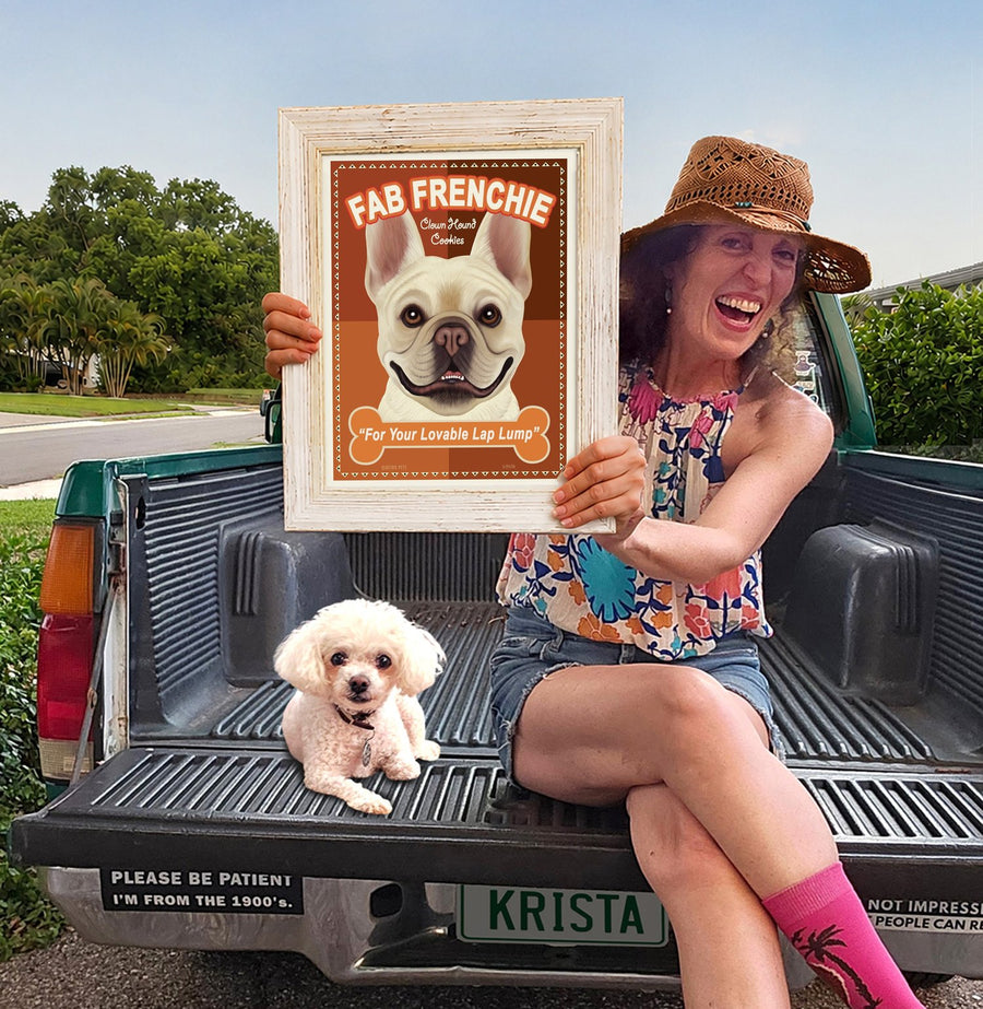 Krista Brooks holding a frame of her Retro Pets art